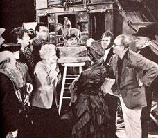 Director John Ford (with hand on hip) & the cast of 'Stagecoach' admire a bronze statue on the set - John Wayne, Claire Trevor, Thomas Mitchell, Andy Devine, George Bancroft